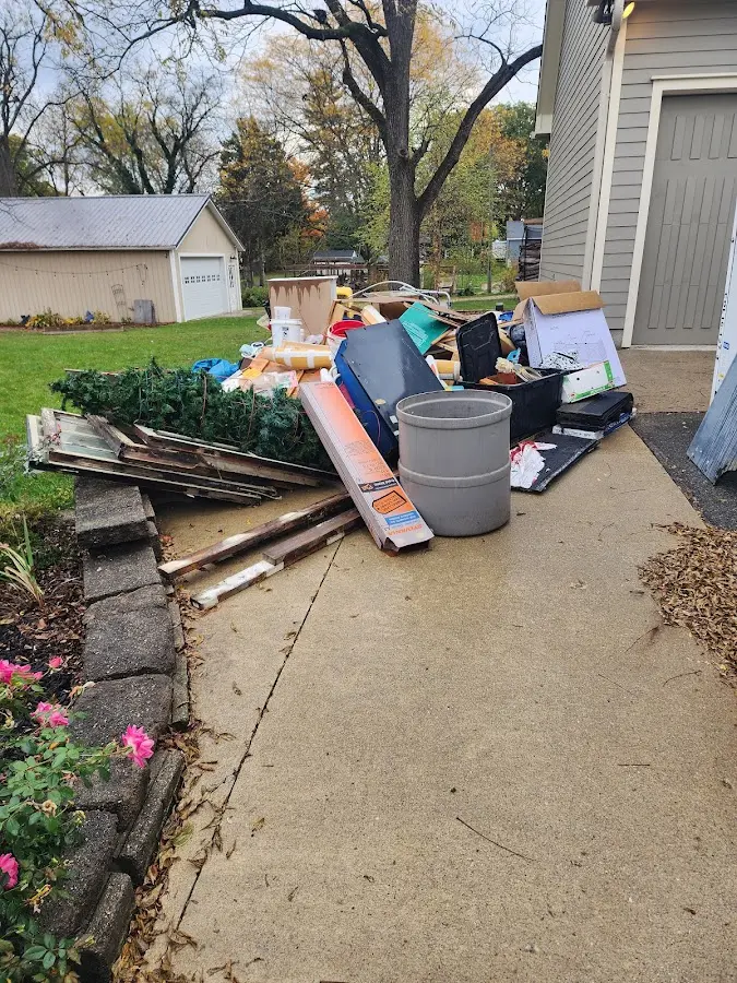 Dumpster being loaded with debris for Estate Cleanout Dumpster Rental in Northwood